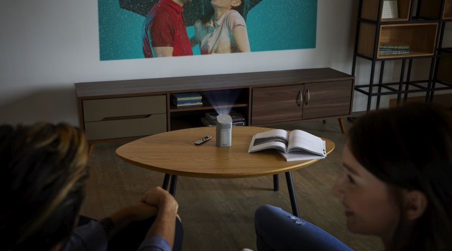 A couple watching a movie using portable projector