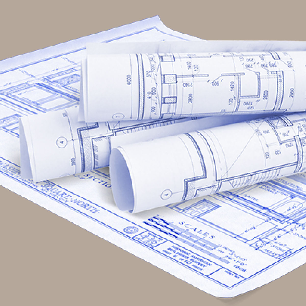 Rolled paper blueprints on top of architectural drawings, representing outdated plans and rework risk.