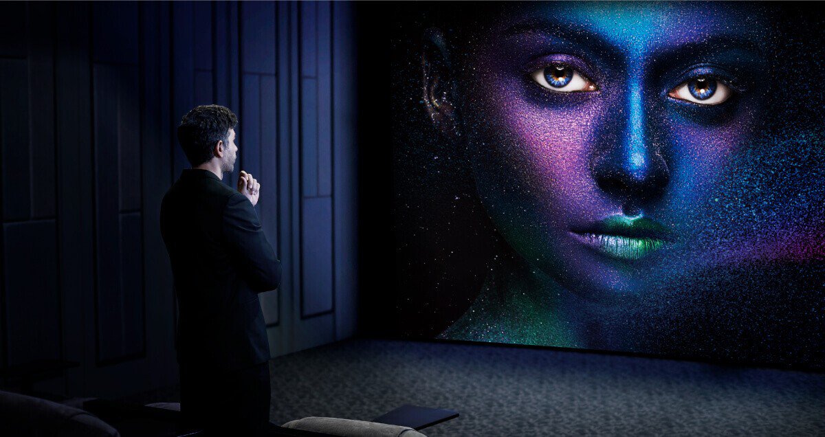 The man is looking at the high-quality image projected by BenQ projector with HDR-PRO technology.