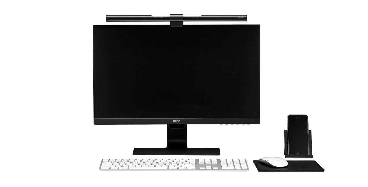 There is a desk setup with a ScreenBar 