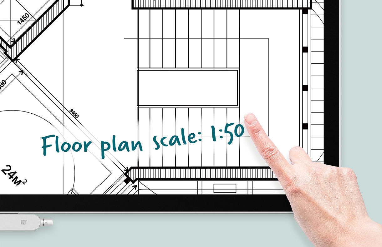 A close-up of a hand sketching on the EZWrite 6 scalable canvas, illustrating the 1:50 scale floor plan visualization on a BenQ interactive display.