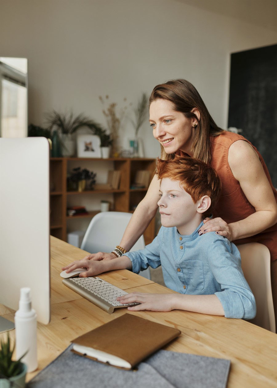 Mom and son staring at the monitor with big smiles on their faces