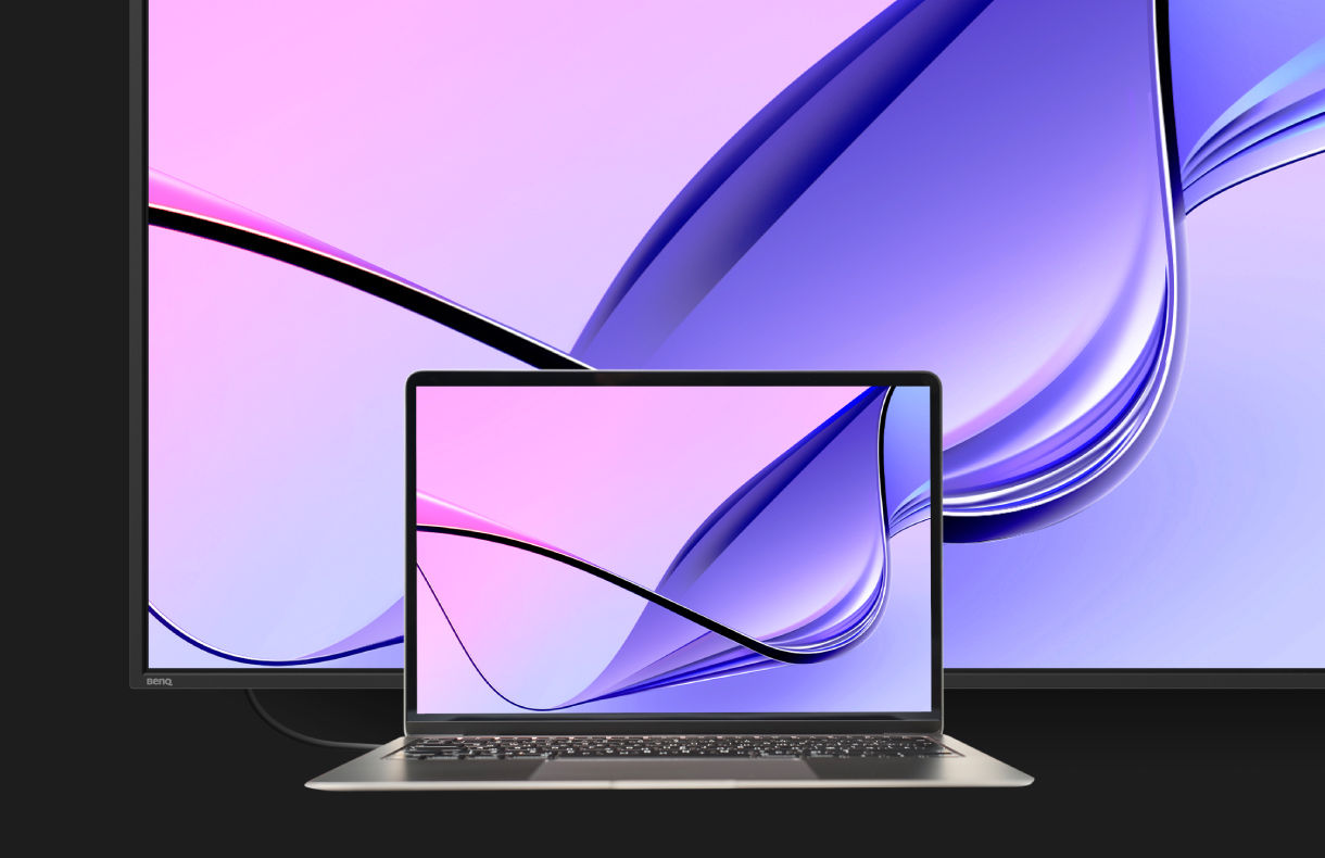 A MacBook laptop screen mirrored perfectly on a vibrant BenQ digital signage display in M-book mode, showcasing consistent color reproduction for professional workplace solutions.
