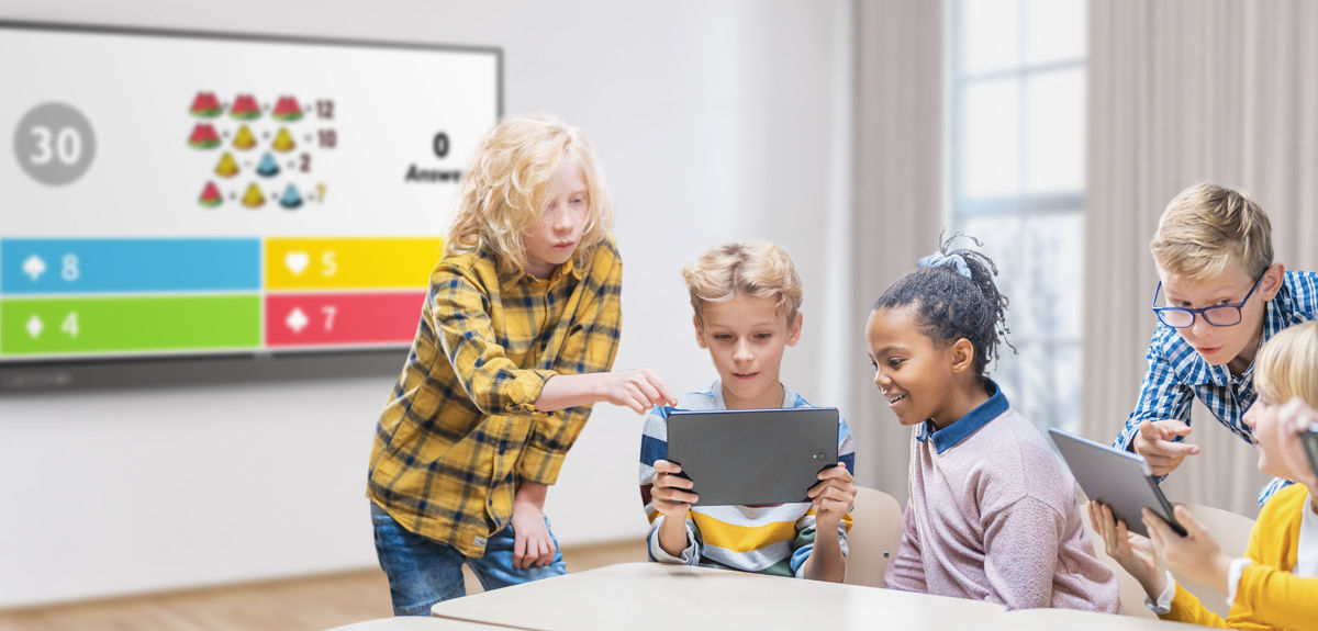 students team-working together to answer a question in a Kahoot! game displayed on BenQ interactive board in the classroom