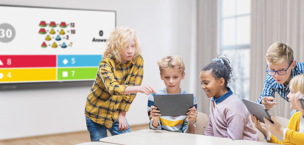 students team-working together to answer a question in a Kahoot! game displayed on BenQ interactive board in the classroom