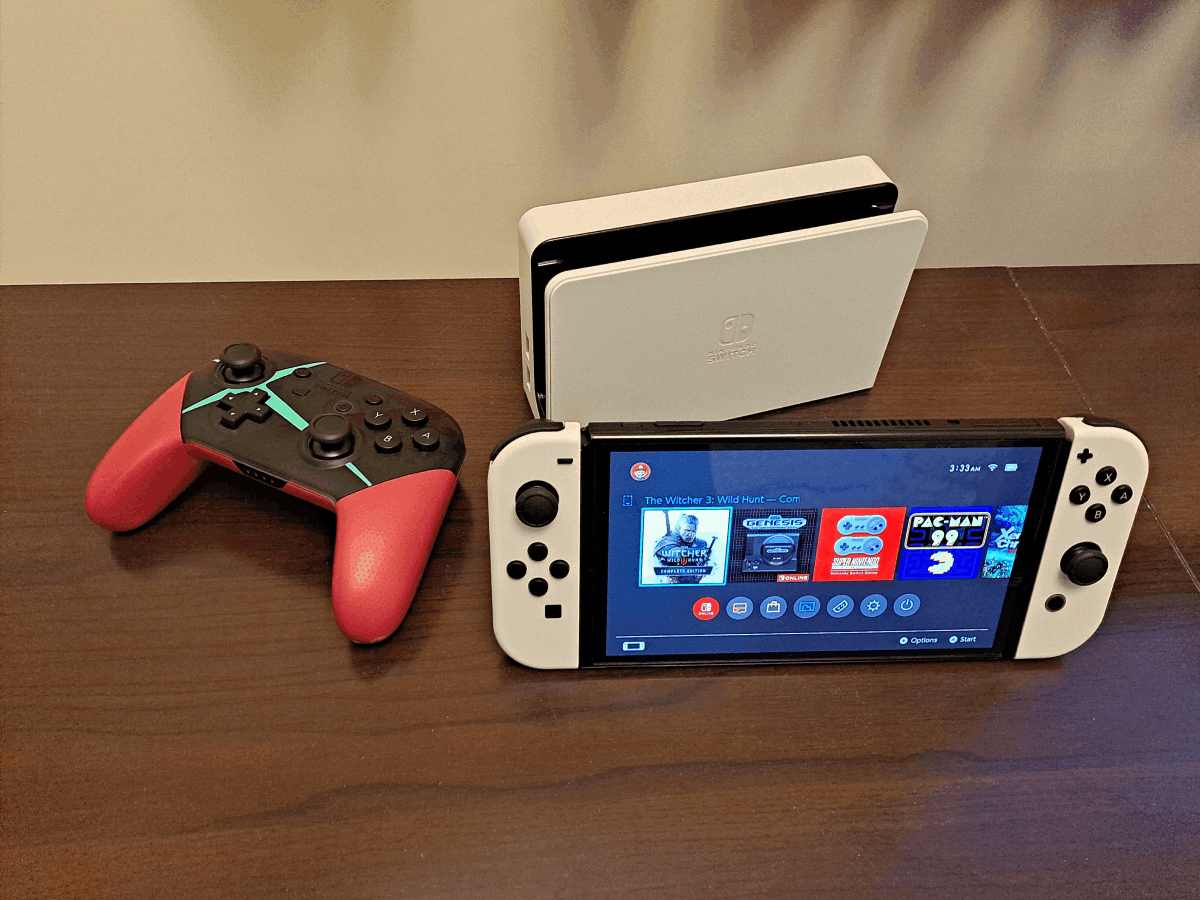 A switch and its gaming dongle are placed on the table.