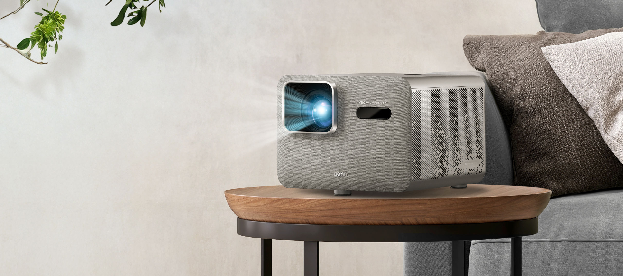 BenQ TK705i 4K HDR home entertainment projector on table in living room