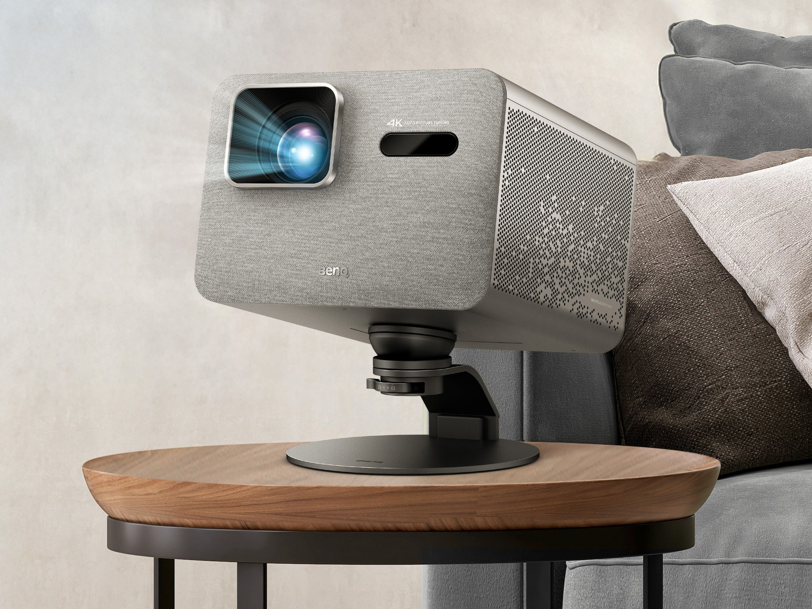 BenQ projector on adjustable stand angled for movie watching in a cozy living room