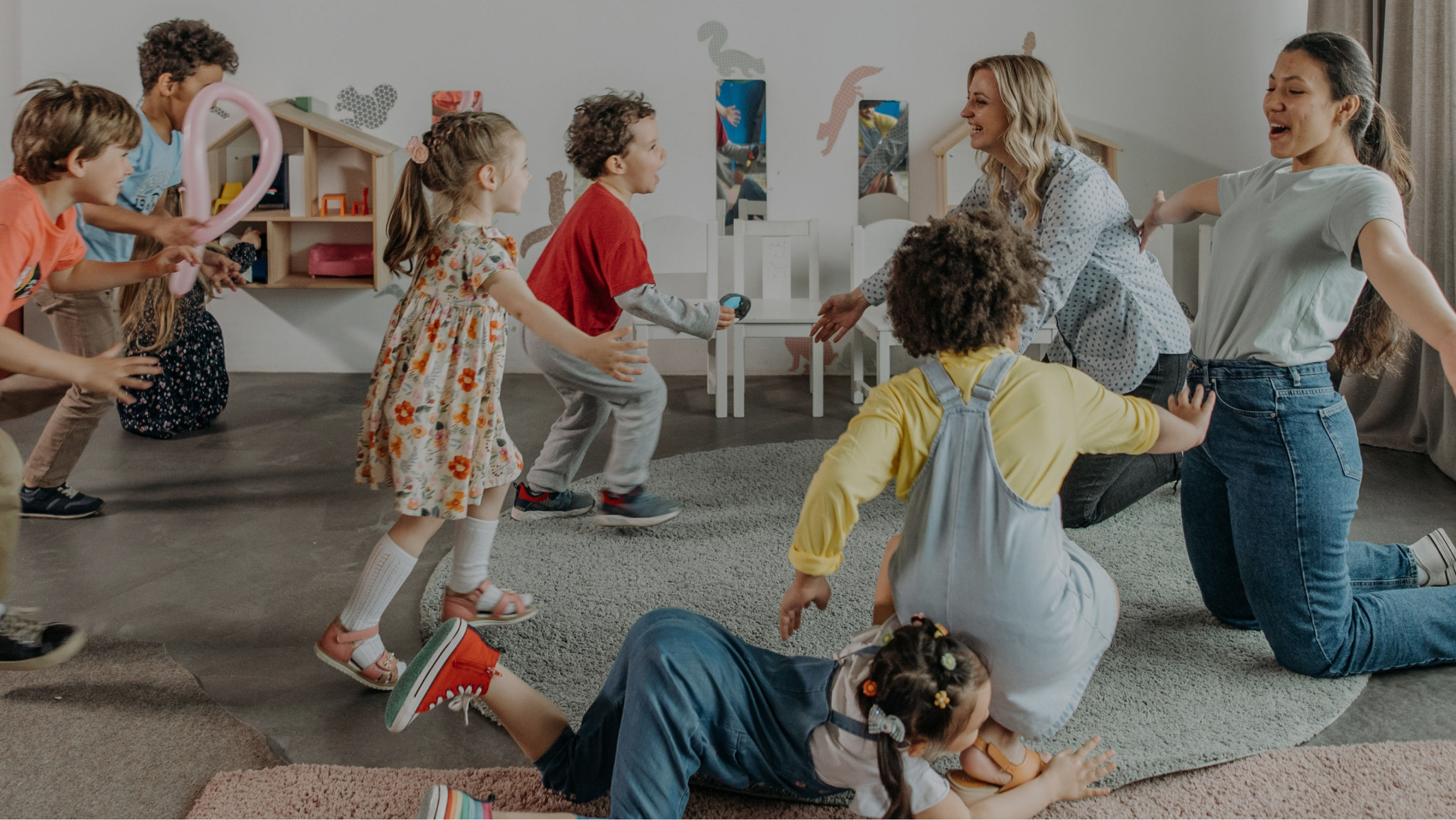 Teachers and young students playing in a classroom