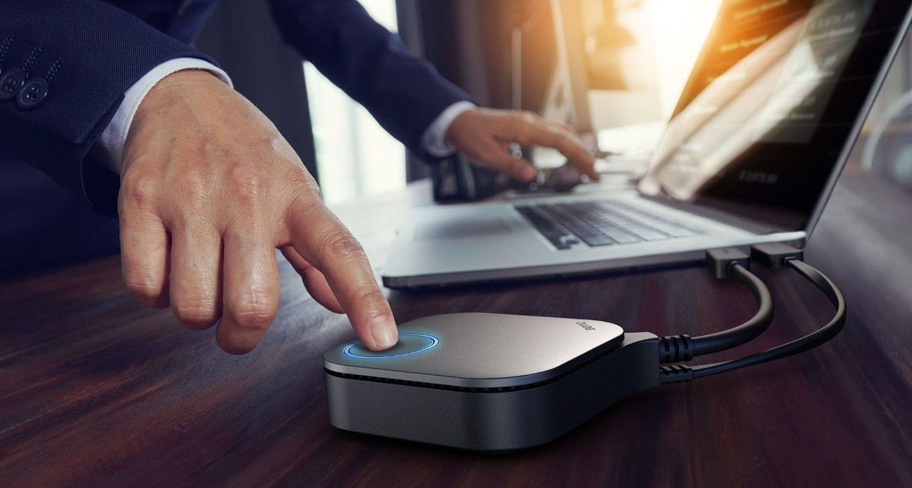 The business man is using wireless presentation system to mirror the screen from a device to a display.