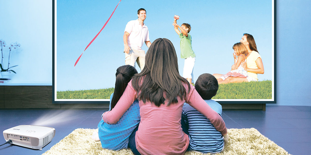 The mother and her two children are watching big screen television with nice and accurate colors.