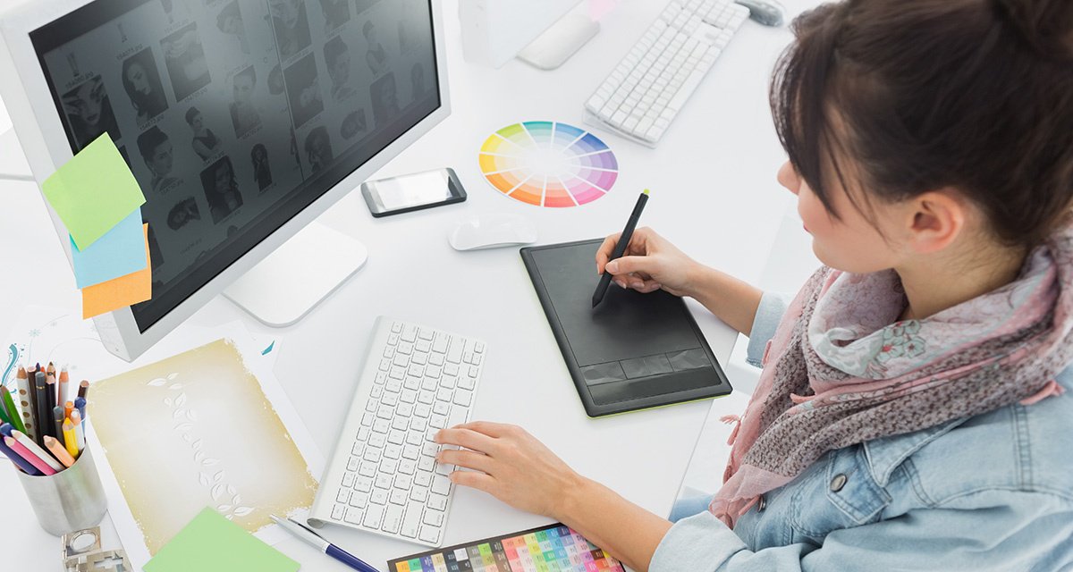 The designer is designing on graphics tablet by using computer software that needs color management.