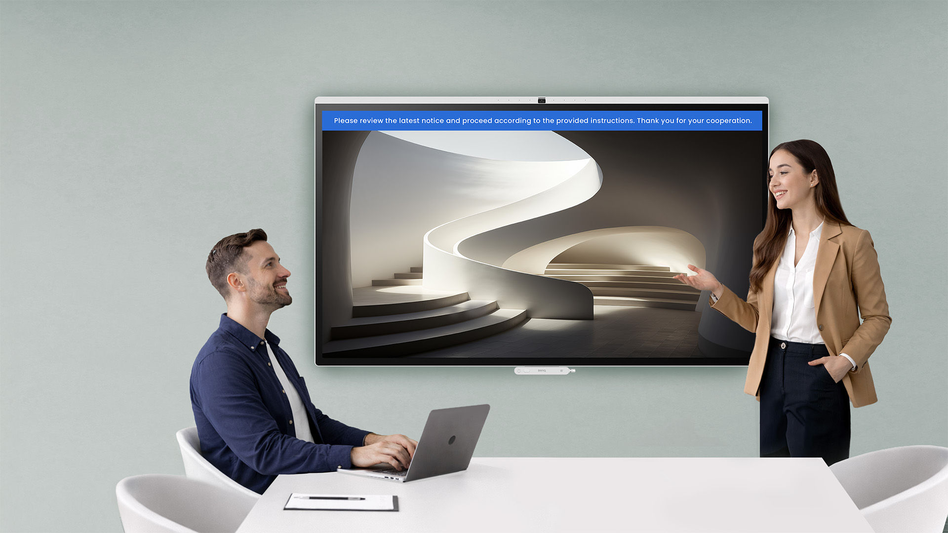 A digital signage display in a corporate lobby showing a workout meetup schedule, managed via X-Sign with remote scheduling from a tablet.